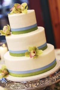 Stax Bakery Wedding Cake small green and pink flowers with a blue and green lining on the cake.