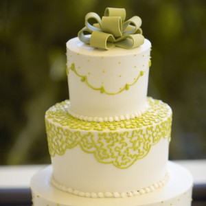 Stax Bakery Wedding Cake with lime green patters and a green edible bow on top of the cake